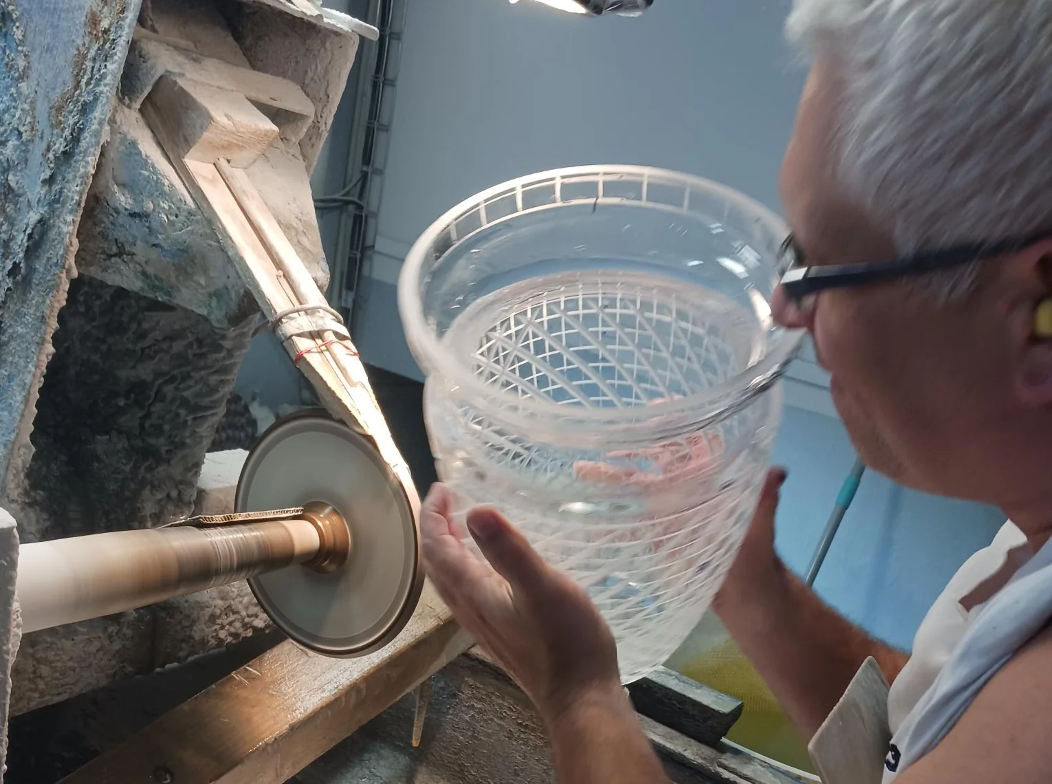 A cutter at the wheel, cutting the facets of a Gabriel piece by hand